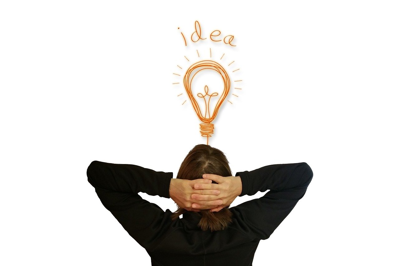 person with hands on head with lightbulb and idea written above