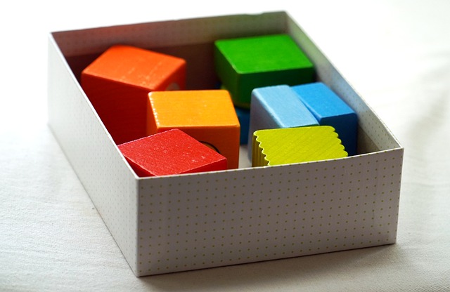 box of colored wooden toy blocks