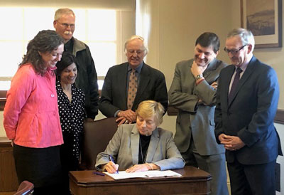 Photo of Governor Mills signing LD1298