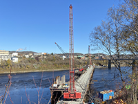 View of cofferdams for piers 2 through 5 with Edmundston, New Brunswick in the background
