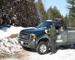 Maine Forest Service ranger outside pick up truck in the winter.