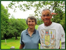 Judy and George Rogers standing in their backyard.