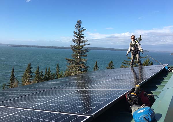 Woman standing atop solar panels