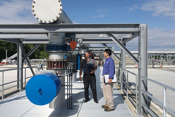 Two men inspecting pipes