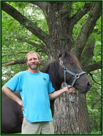 Hary Dwyer standing with is horse.