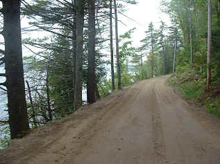dirt camp road next to lake