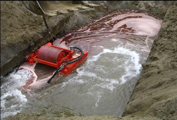 Drum skimmer collecting #2 fuel oil in an excavation in Augusta