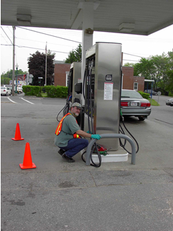 DEP staff inspecting a dispenser