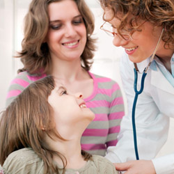 doctor examining smiling child