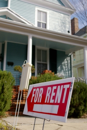 for rent sign in front of apartment building