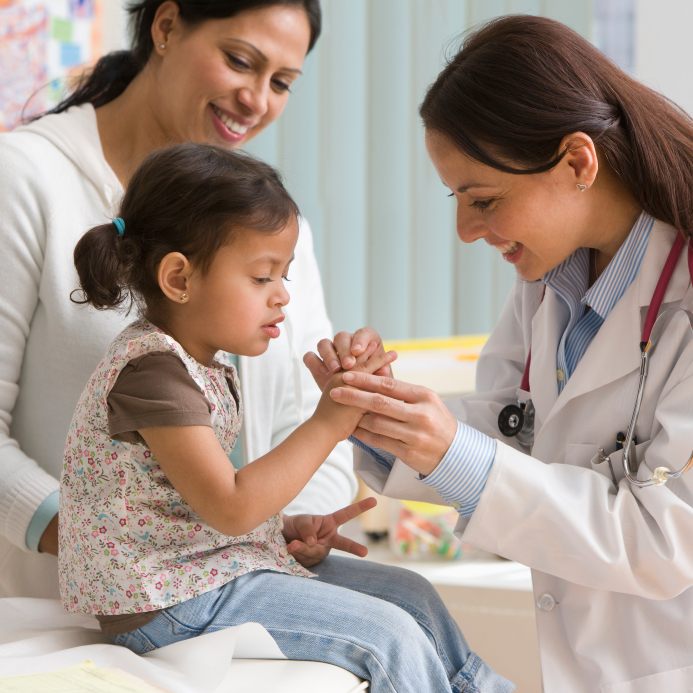 doctor examining child's finger