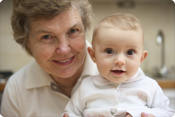 an older woman holds an infant