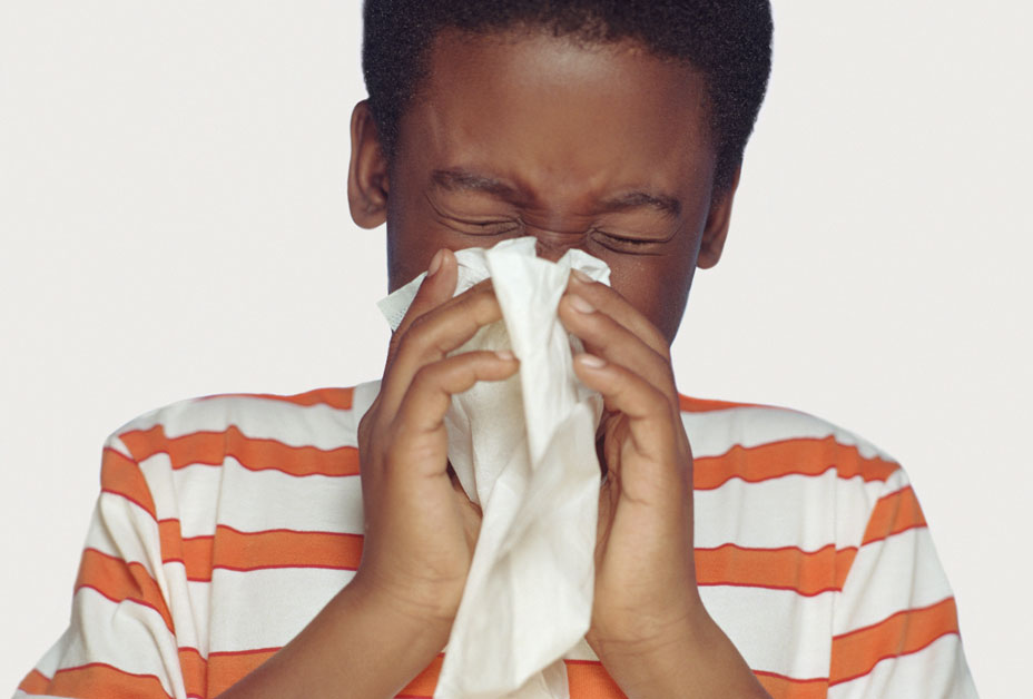 child blowing their nose