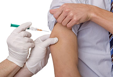 Man receiving vaccination in right arm