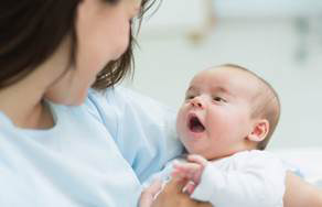 photo of young mom holding a newborn baby.