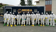 Maine DEA staff in hazmat suits in front of trailer