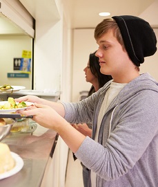 Filling a food tray.