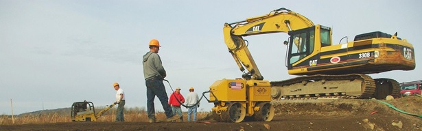 Backhoe on road, photo by Slade Moore