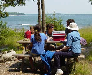 A family enjoys a picnic and the views