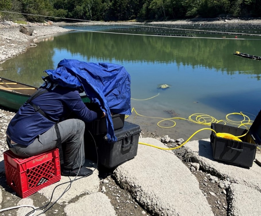 Image 1. MDMR Aquaculture Division staff Geoff Shook operating the ROV from shore during a site assessment in a tidal impoundment. (Picture credit: Meryl Grady)