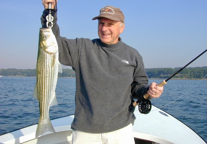Man holding striped bass