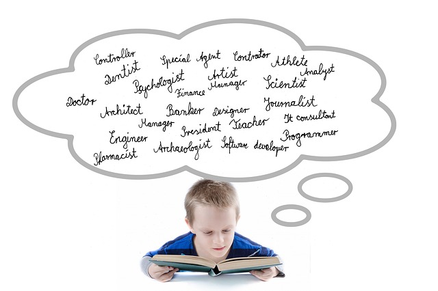 boy looking in an open book with a thought bubble above thinking about different professions