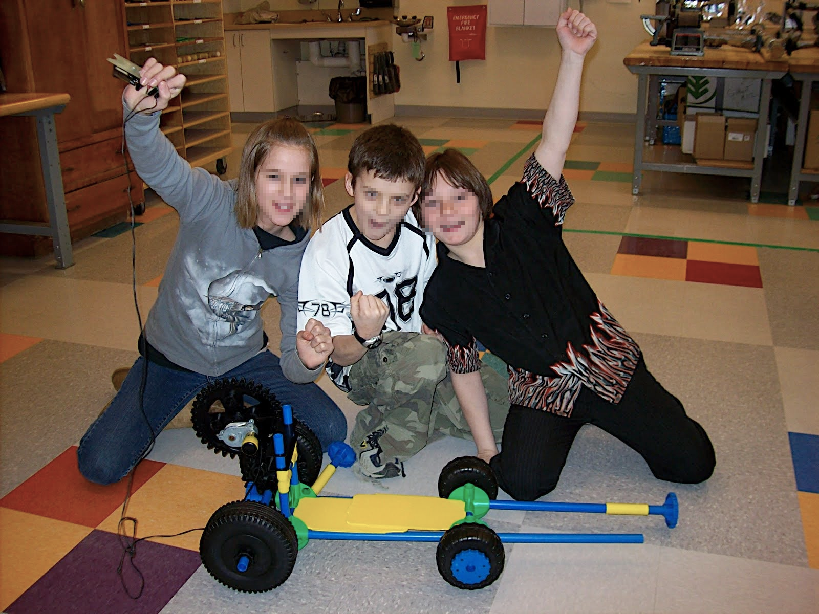 Students Cheering winning race after building toy car