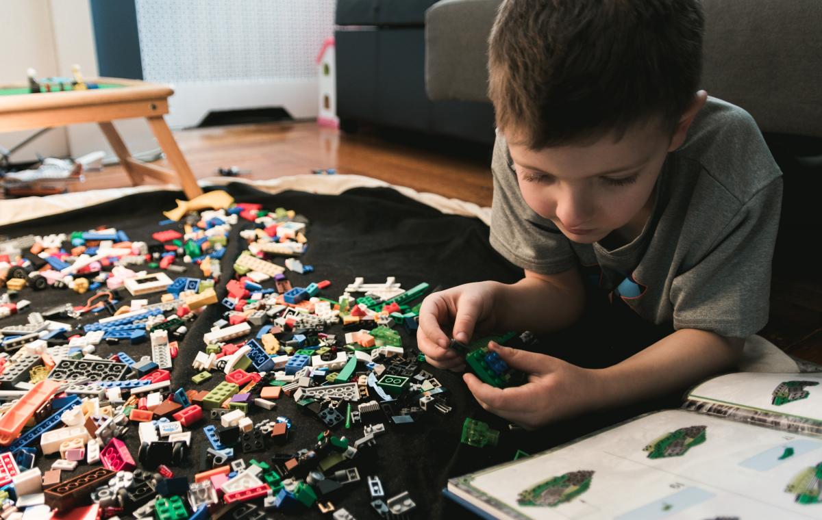 Child building with Lego blocks