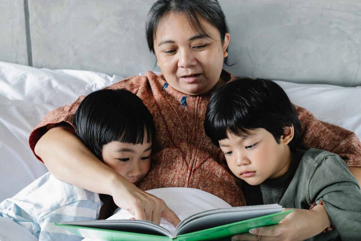 Woman reading to two children