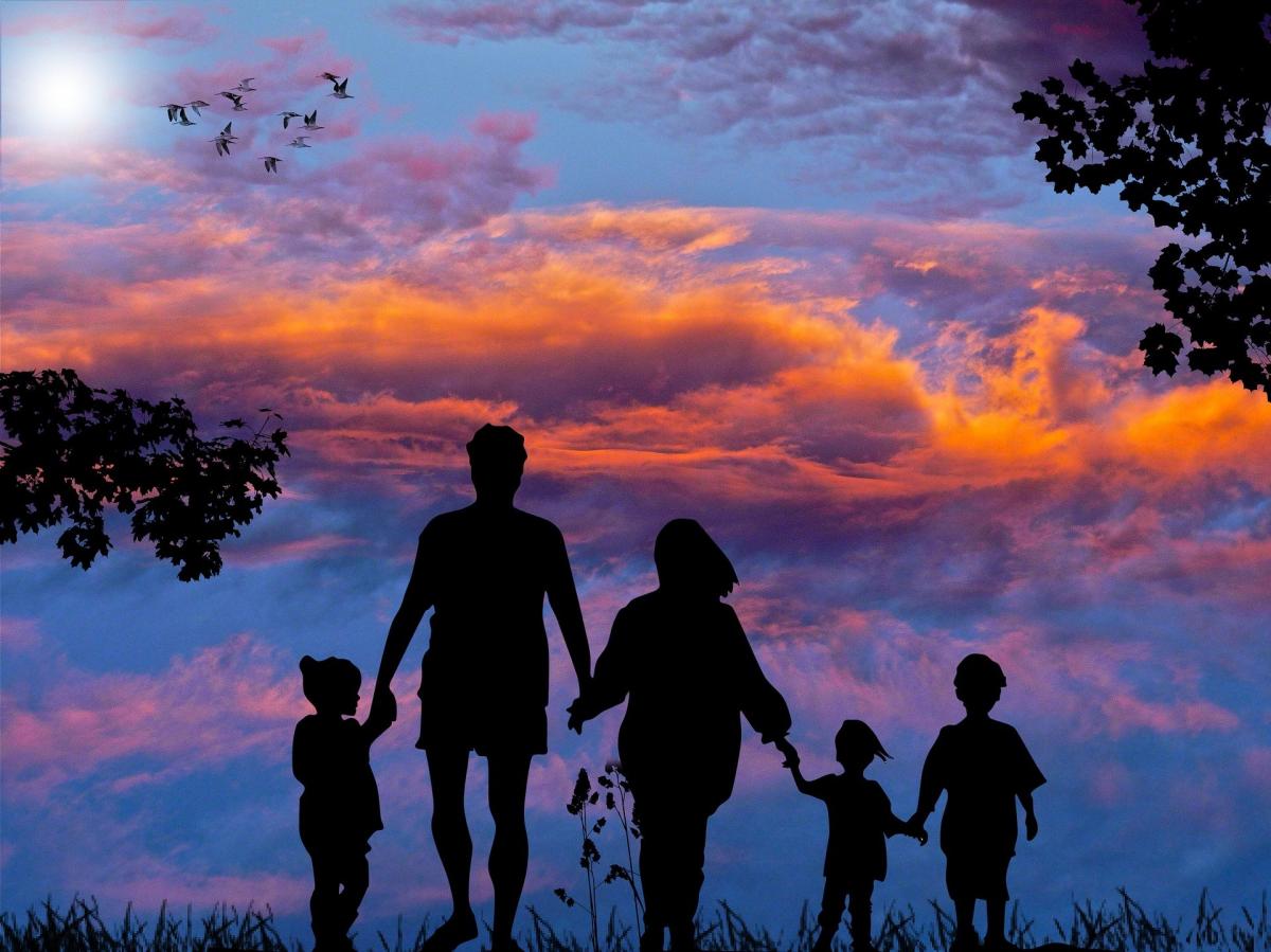 blue sky with colorful clouds and 5 family members holding hands