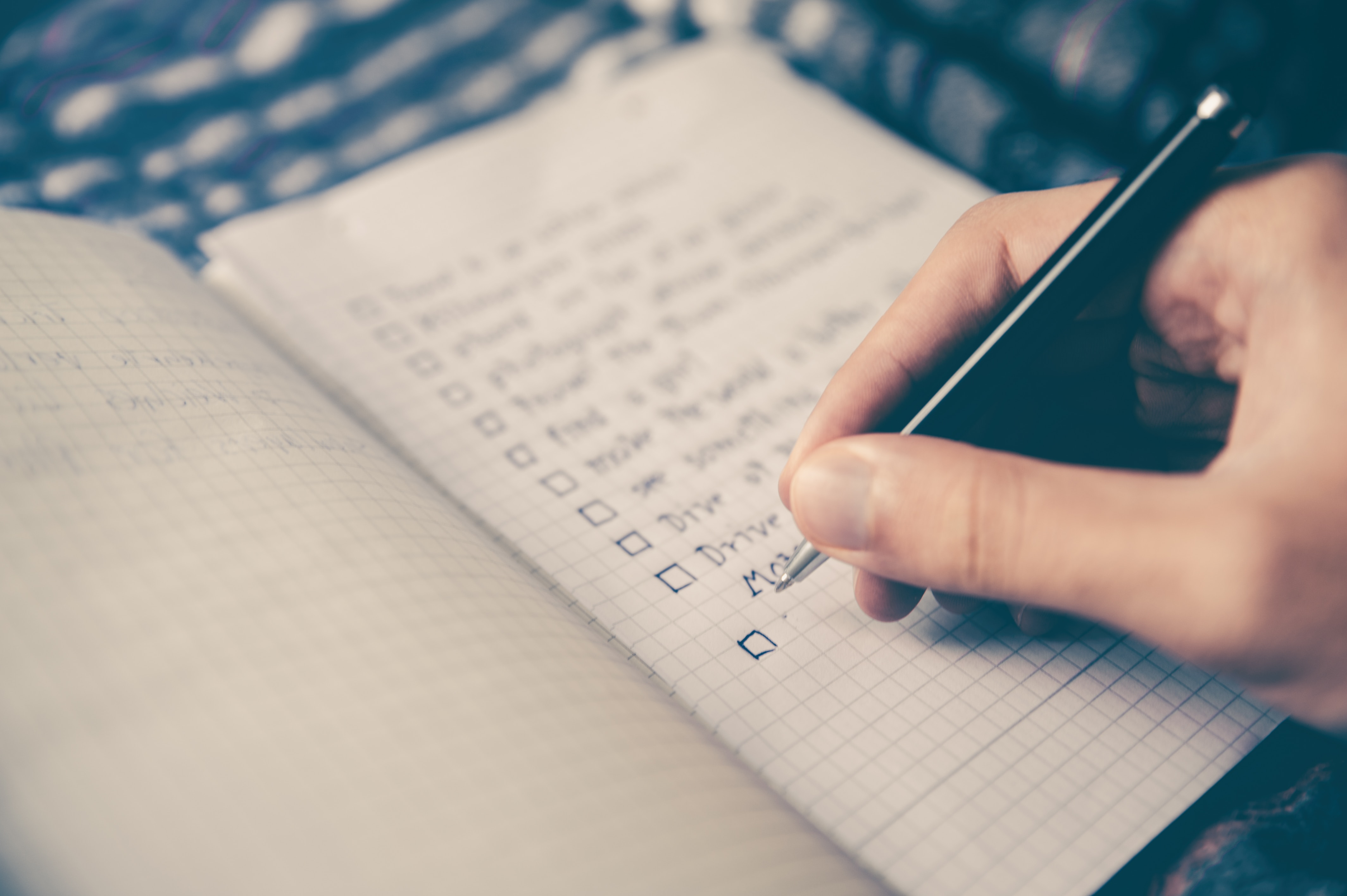 person writing in notebook