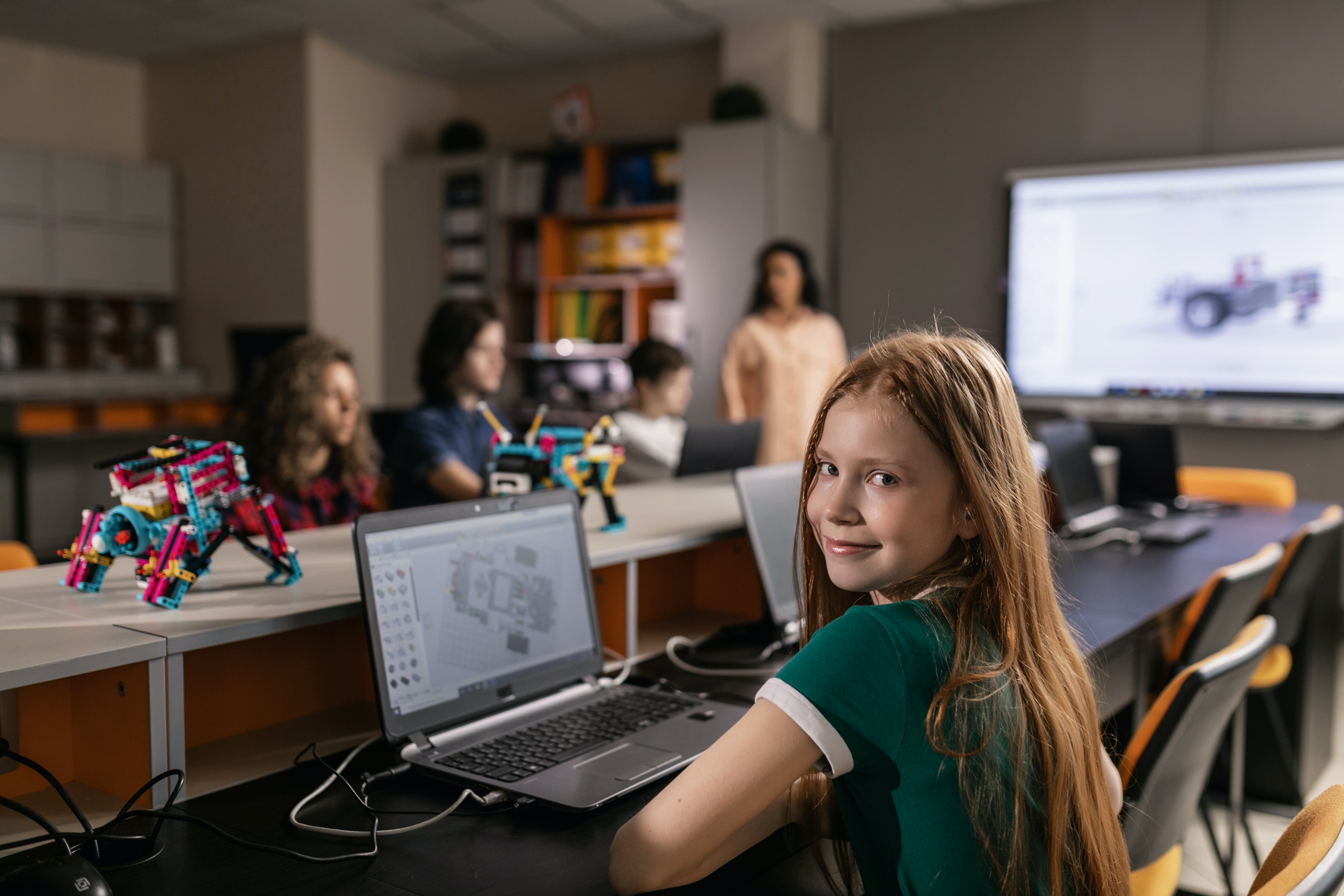 student with laptop and robotics