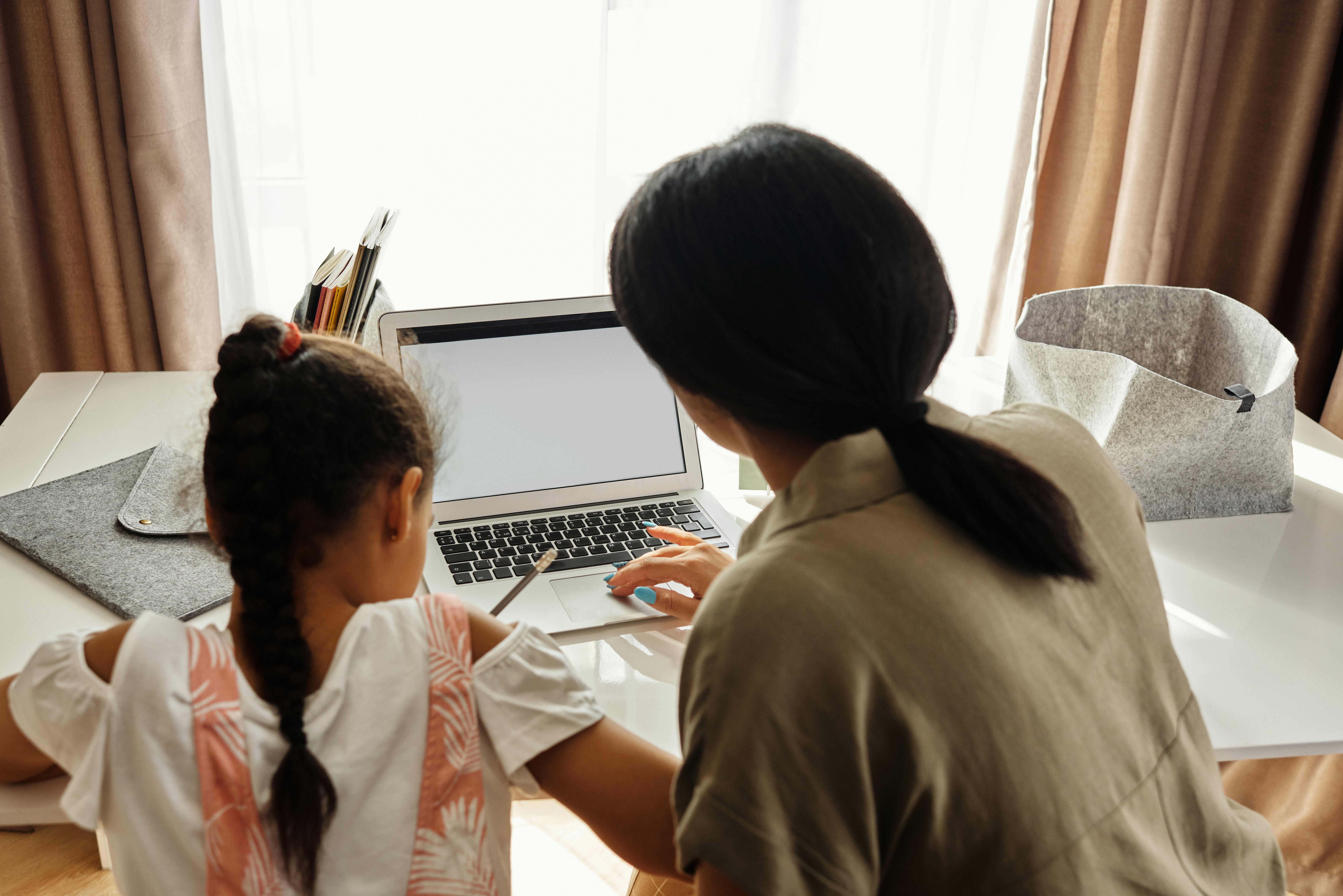 Adult woman showing child information on a computer