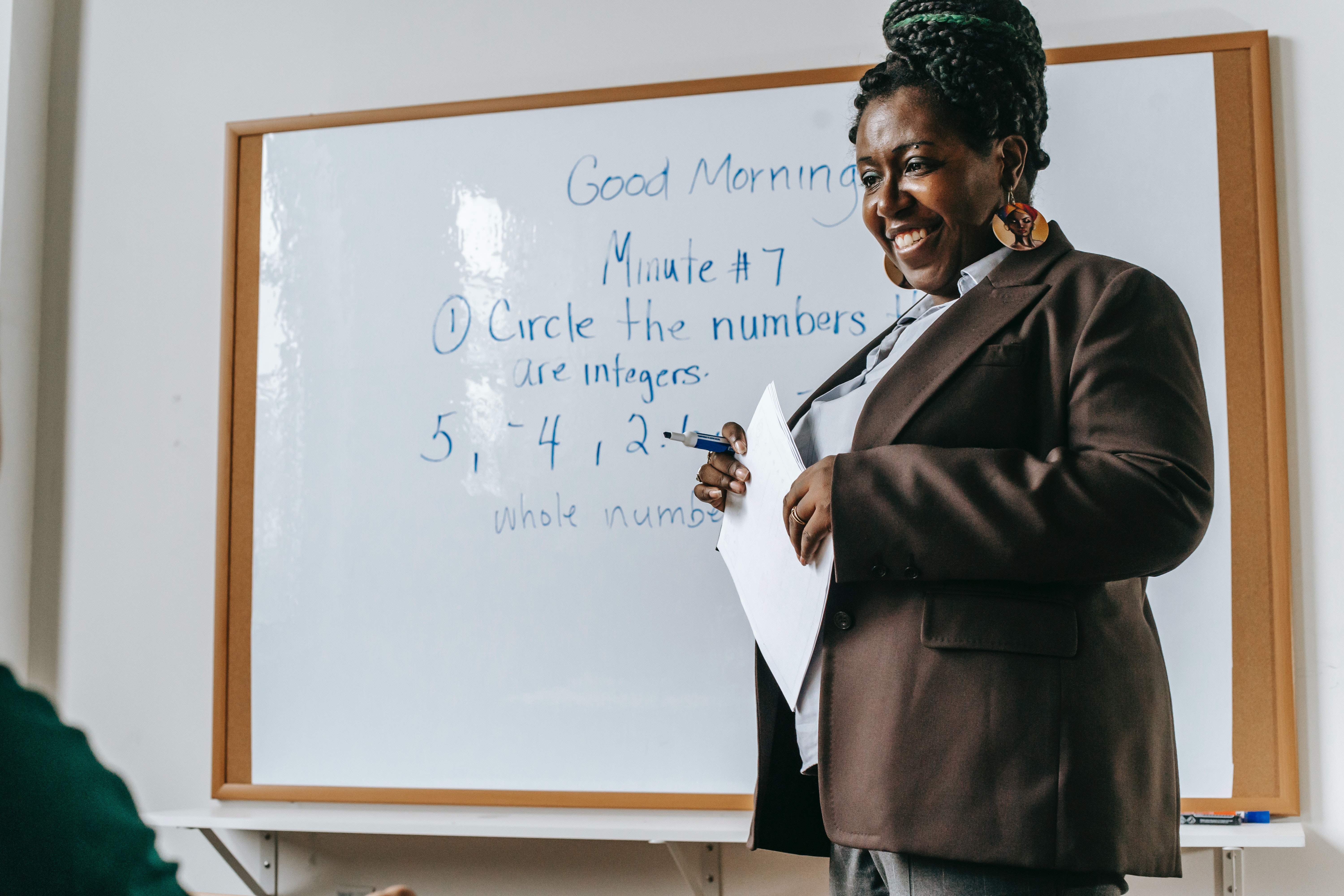 Person near whiteboard teaching class