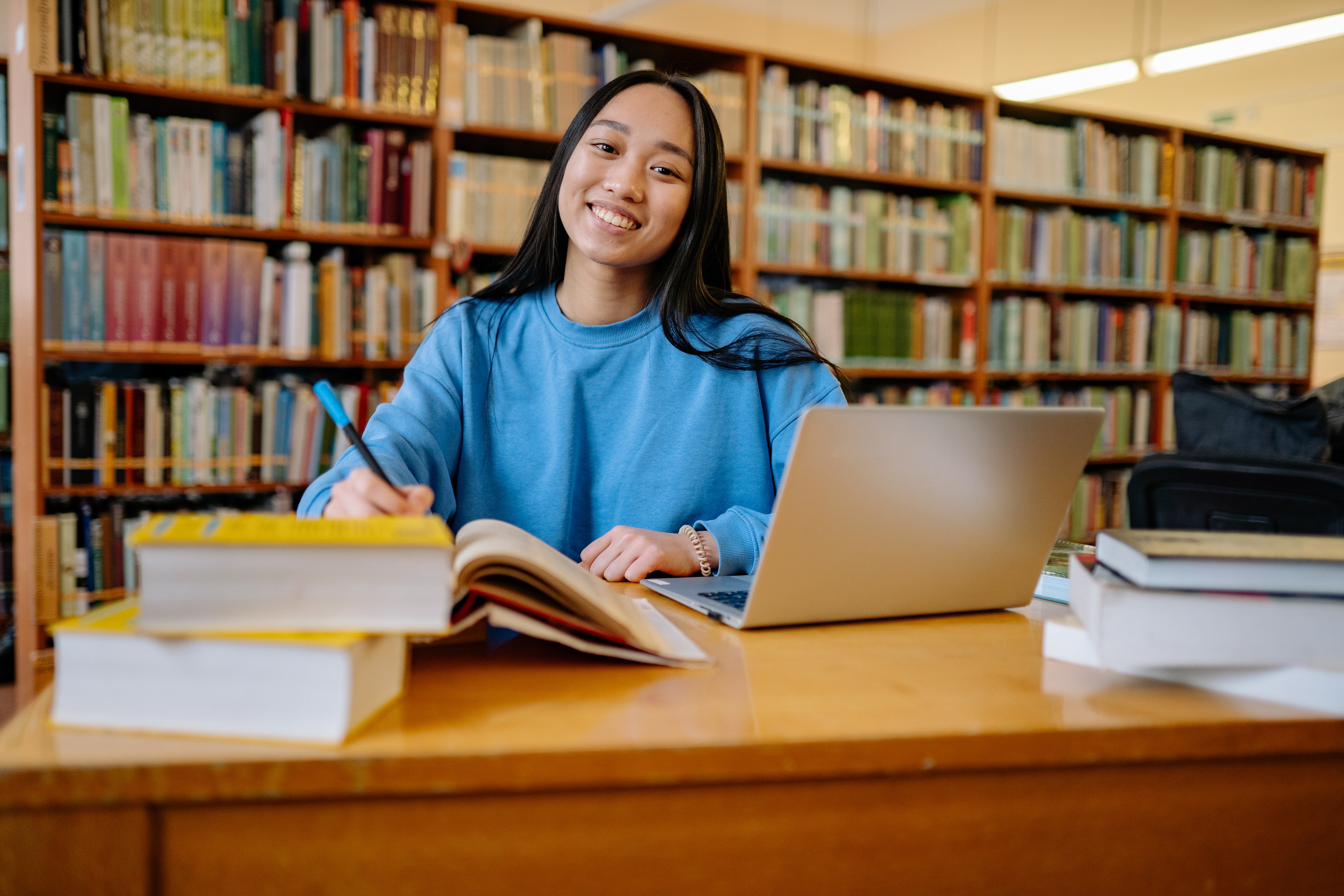 student in library with book