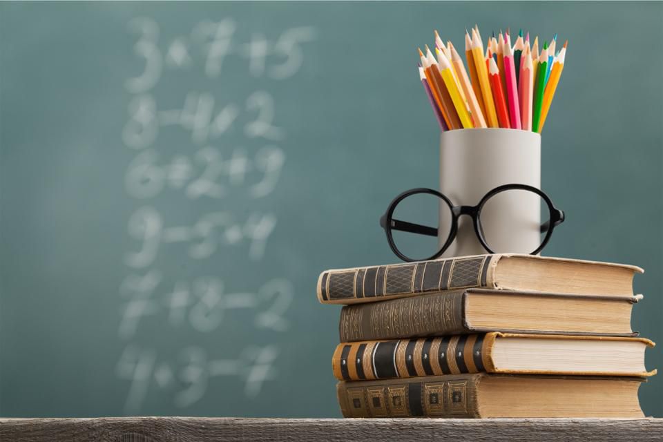 chalk board, books, glasses