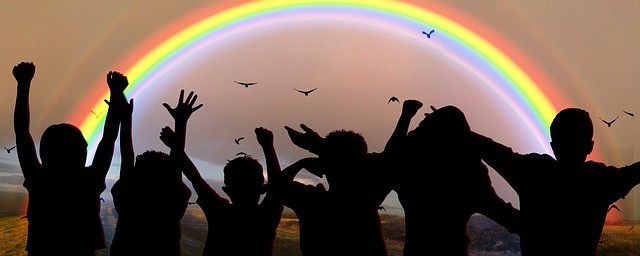 group of children looking at a rainbow