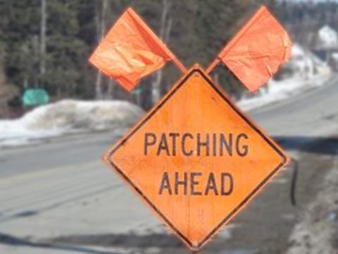 a sign that reads "patching ahead"