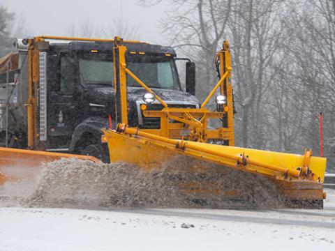 a snowplow plowing the road