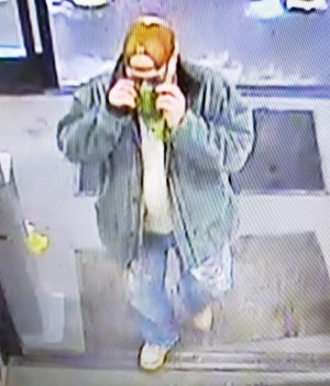 Unidentified subject wearing green banadana blue jeans light gray coat