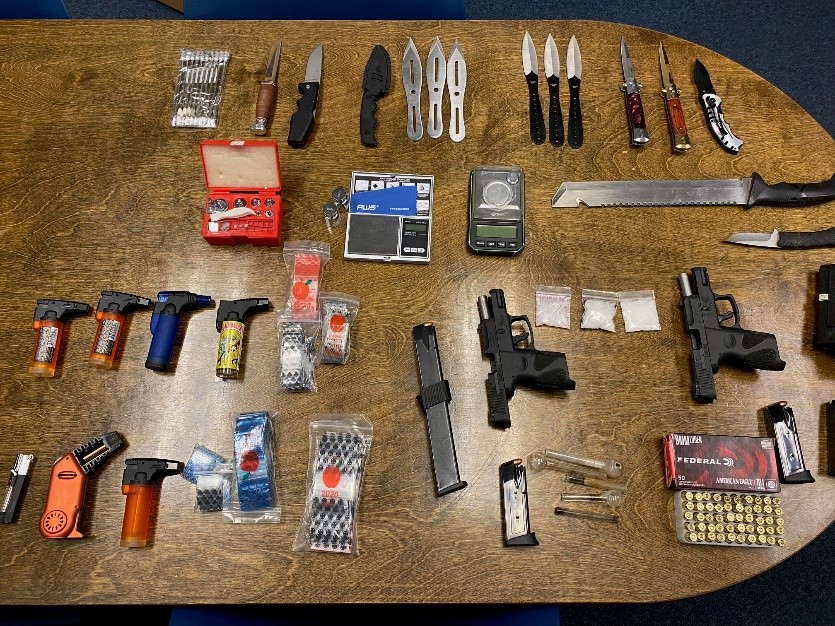 Troop D evidence from arrest, including knives, ammo, and firearms