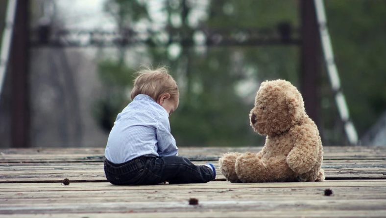 Child and teddy bear photo