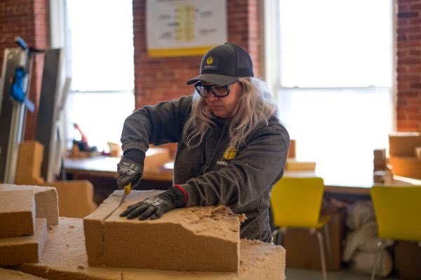 Woman cutting a block of insulation
