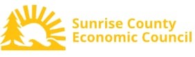 Sunrise County Economic Council logo, text next to a yellow sun icon rising over waves and a pine tree