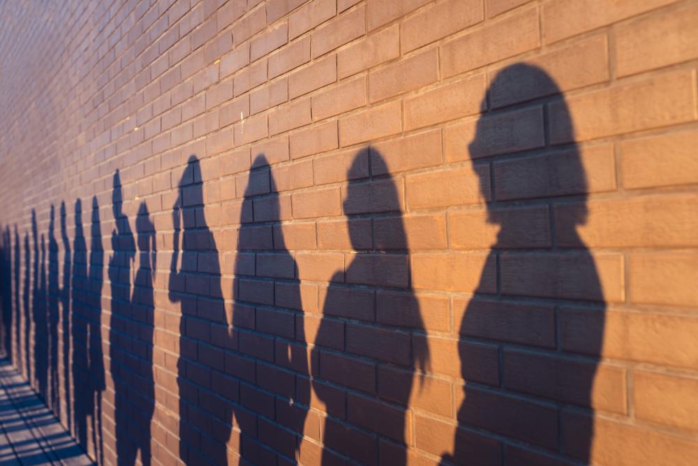 Line of people in shadow