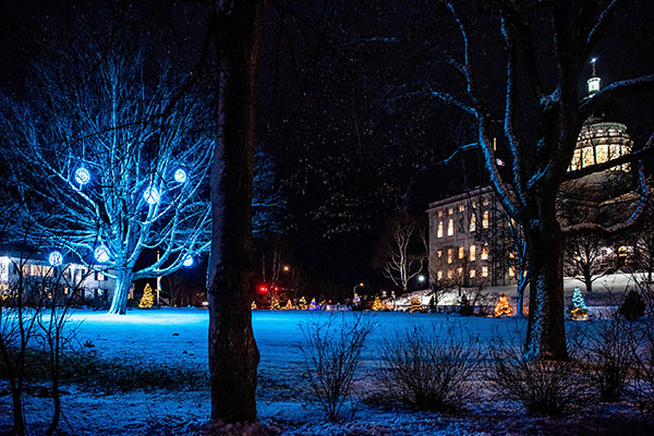 Photo of the Capitol at night with Christmas decorations