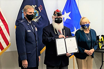 Photo: Major General Douglas Farnham (left), PO3 James Bachelder (center), and  Governor Janet Mills (right) at the Aides-de-Camp induction ceremony