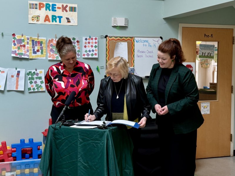 Governor Mills ceremonially signs the provision of the budget including the expansion of Maine’s Free School Meals Program alongside Laura Larson of Family Focus and Senate President Daughtry