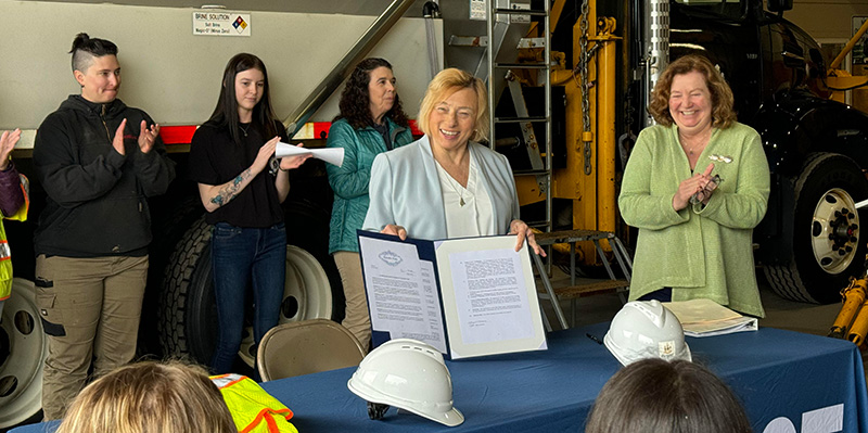 Governor Mills holding a copy of the Executive order