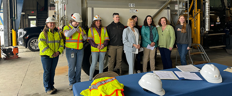 Governor Mills standing with construction workers